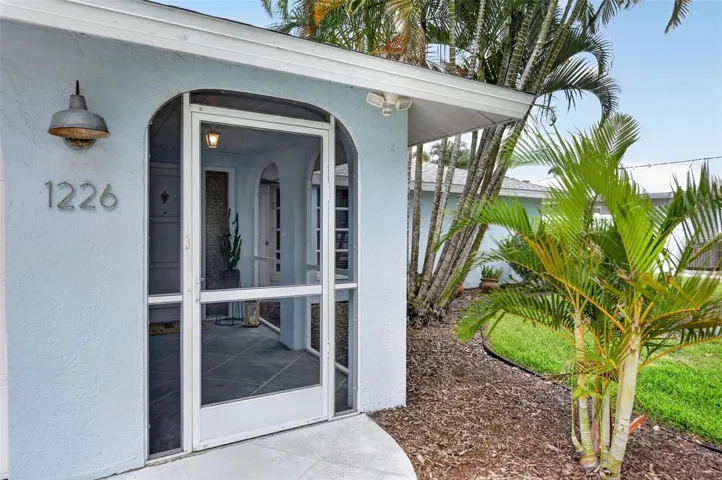 Front door with screened in entry way