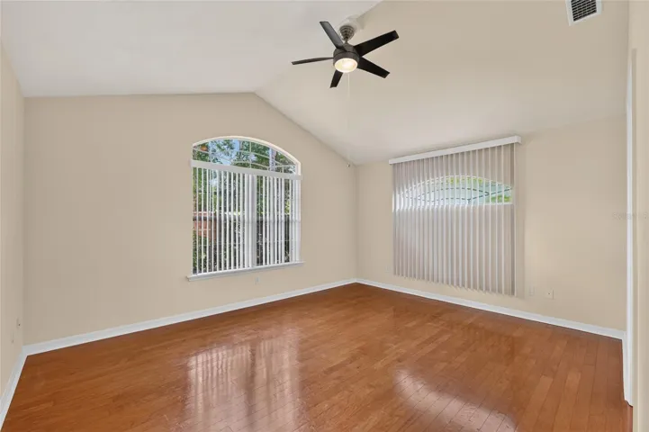 PRIMARY BEDROOM WITH WOOD FLOORS