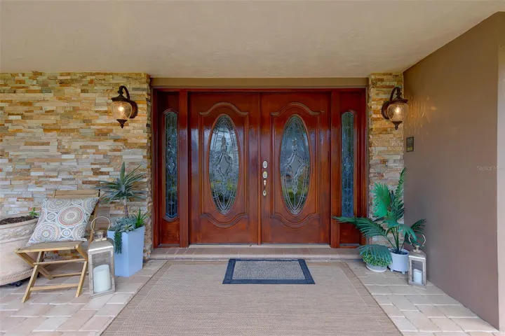 Double door entry to the home, stacked stone entrance