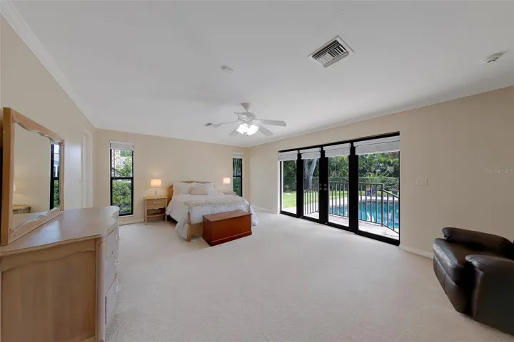 Bedroom 4 is another large master with walk in closet overlooking the pool