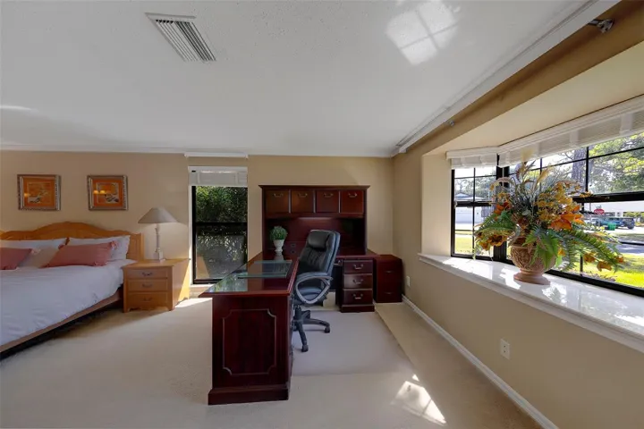Could be a small office or sitting area. Nice Bay Window accents the master