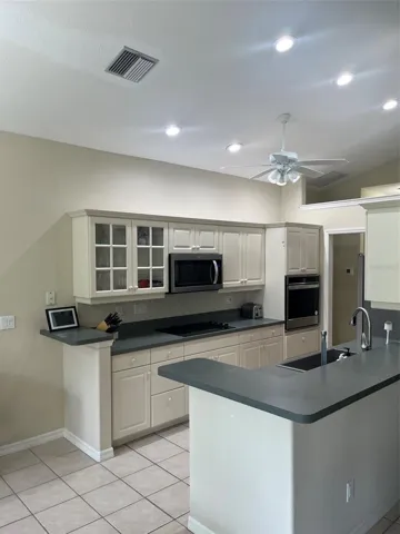 Kitchen opens to living area and dining area.