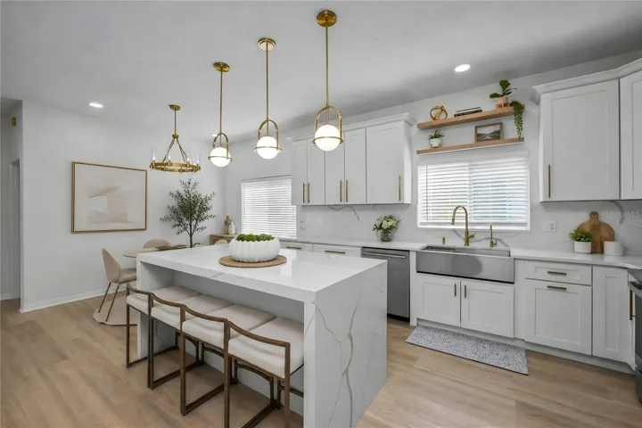 Designer kitchen with waterfall-edge quartz island and open layout