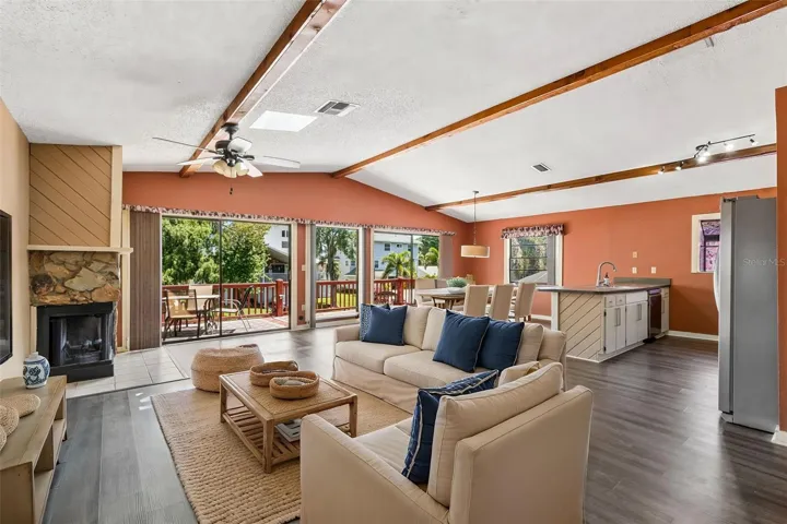 Fabulous open floor plan, with vaulted ceilings, decorative wood beams, skylight, luxury vinyl floors and fireplace.