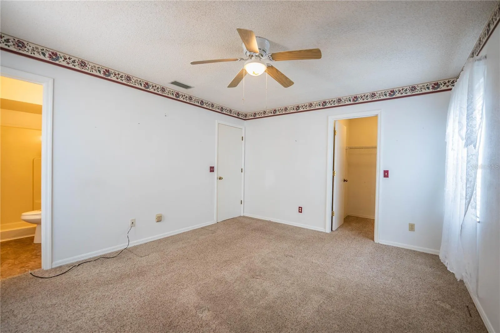Primary bedroom, closet and bathroom