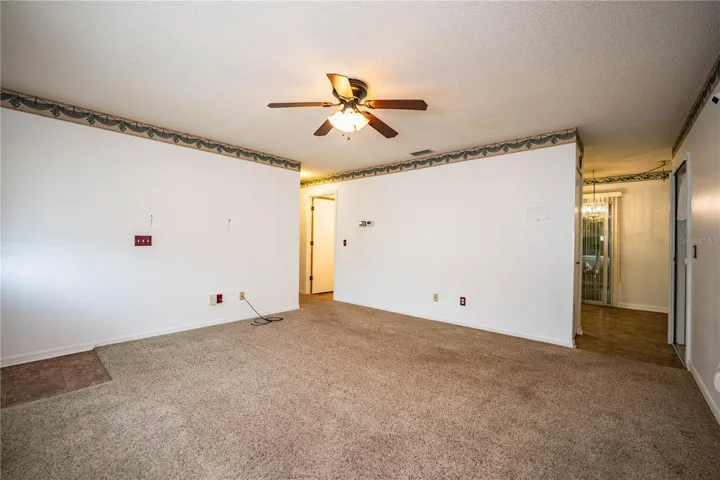 Living room looking into kitchen and down hall