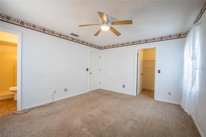 Primary bedroom, closet and bathroom