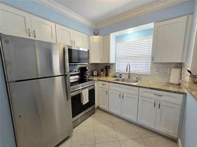 The kitchen has brand new stainless steel appliances, granite counters and quality wood cabinets with soft close doors.  All kitchen equipment, pots, pans and silverware convey.