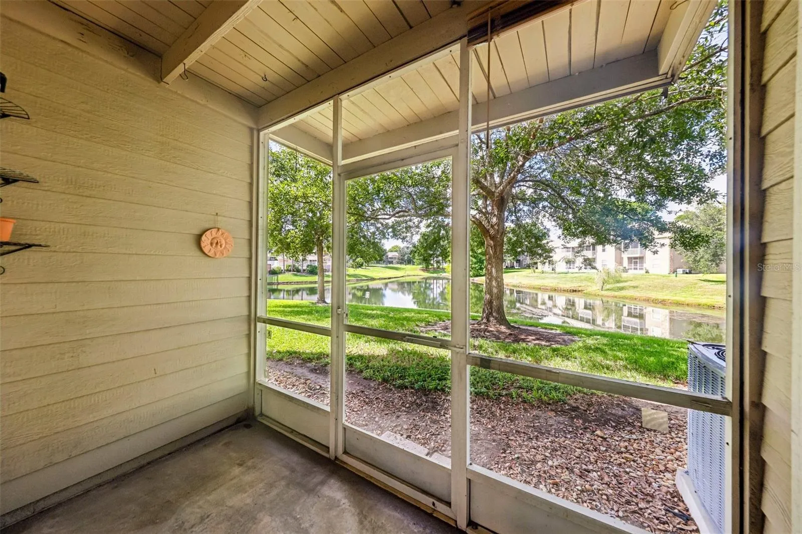 Screened lanai has pond views.