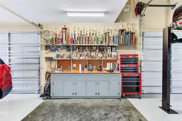 garage bonus area with cabinets & counter top