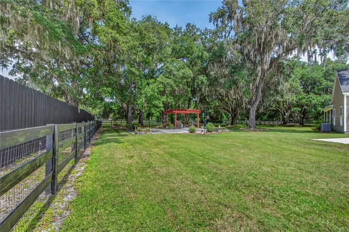 grass & mature oak trees + completely fenced property