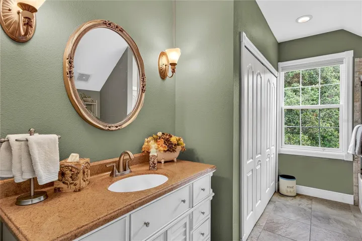 large counter top, closet, window in 2nd full bathroom