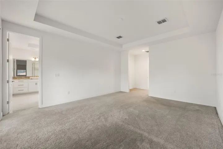 Primary bedroom with trey ceiling