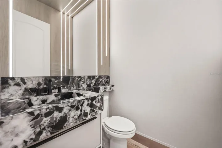 Downstairs half bath with Brazillian Cristallo Quartzite countertop