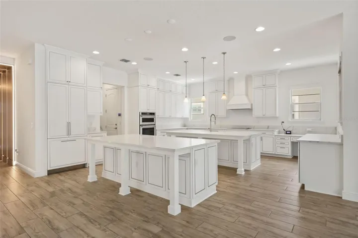 Gourmet kitchen with two oversized islands and built-in Thermador refrigerator