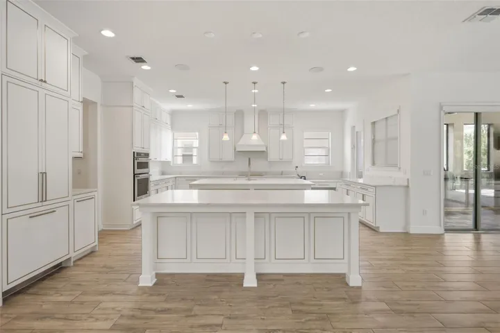 Gourmet kitchen with two oversized islands and built-in Thermador refrigerator