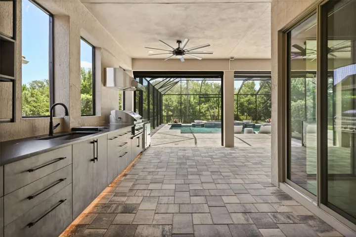Summer kitchen complete with grill, sink, nugget ice machine, and two drawer refrigerators