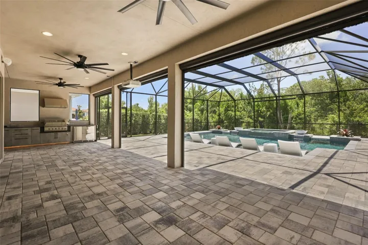 Summer kitchen complete with grill, sink, nugget ice machine, and two drawer refrigerators