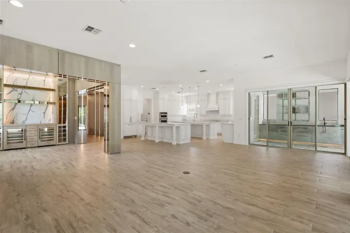 Gourmet kitchen with two oversized islands and built-in Thermador refrigerator