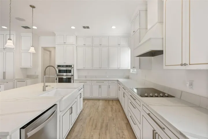 Gourmet kitchen with two oversized islands and built-in Thermador refrigerator