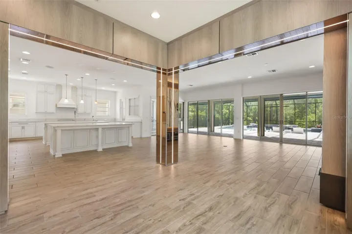 Gourmet kitchen with two oversized islands and built-in Thermador refrigerator