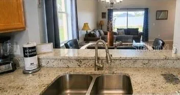 Kitchen open to living room with breakfast bar