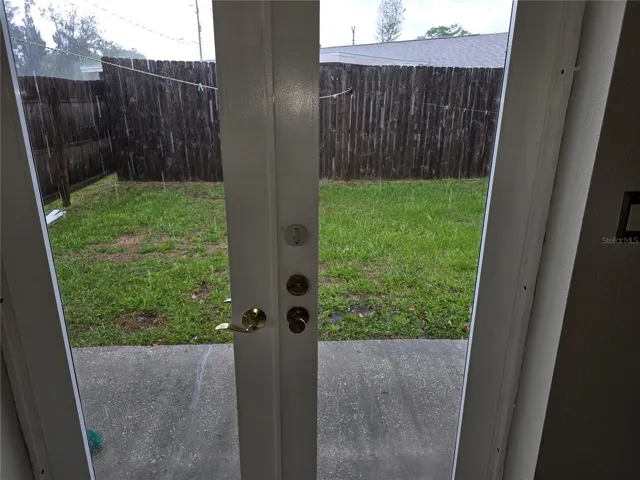 DOUBLE DOORS LEADING TO BACKYARD