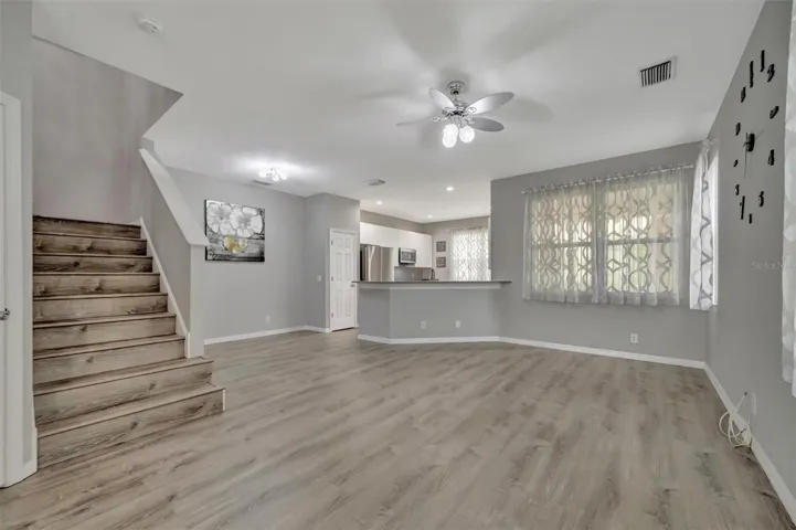 Front Entrance leading to the Living Room, half bath to the left of the stairs