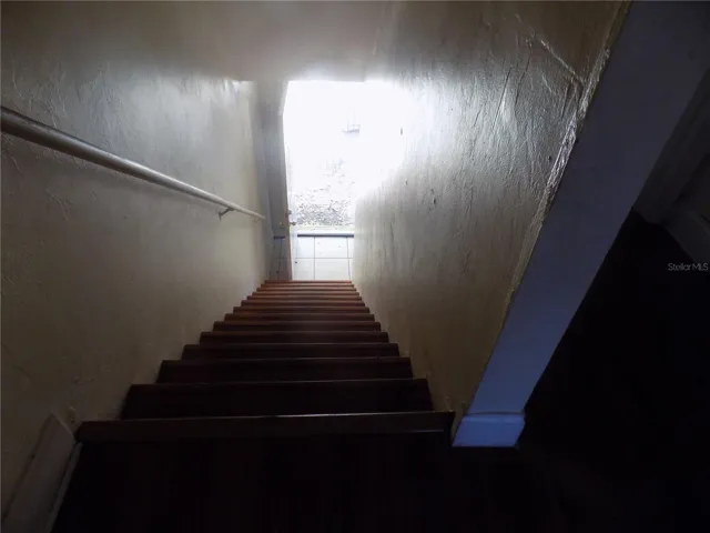 A stairs look down to front door