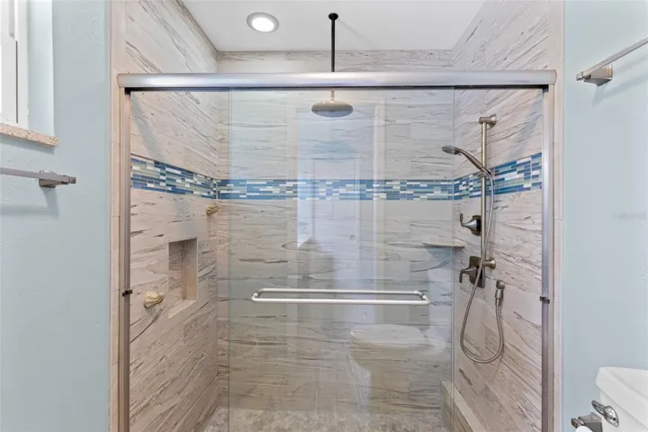 Shower head and glass enclosed shower in the primary bath