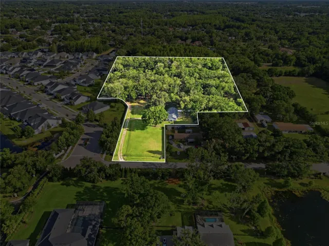 Aerial View with property boundary outlined (This is outlining the entire property including adjacent 2+ acres with sister house and shed)