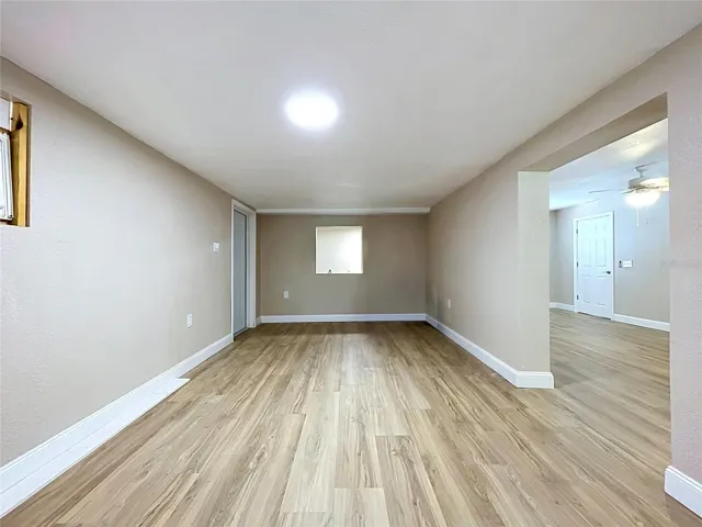 FLEX SPACE ON THE WEST SIDE OF THE HOME, DOOR ON LEFT EXITS TO THE WEST SIDE YARD.  LAUNDRY AREA AT THE BACK ON THE OTHER SIDE OF THE PASS THROUGH