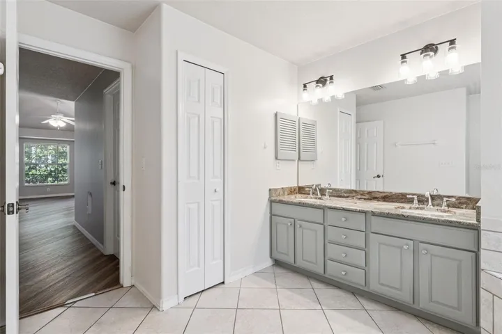 Primary Bathroom with Granite Counters and Double Sinks.