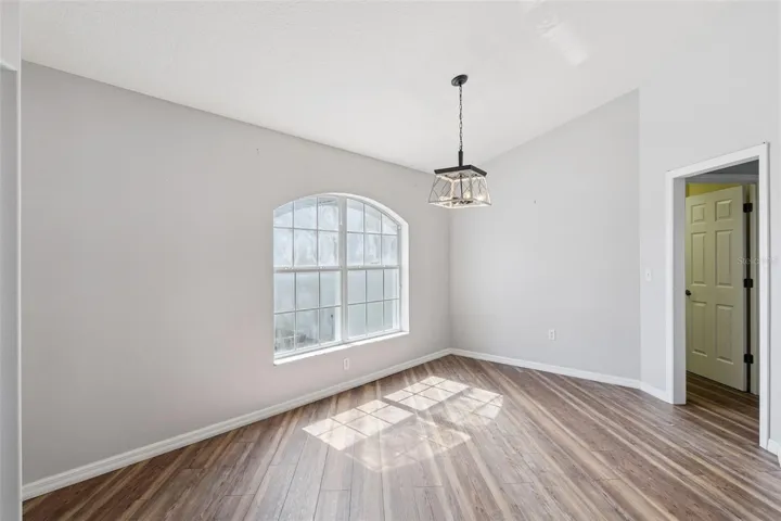 Dining Room - 14.8 X 10.8 - Arched Window and Pendant Lighting.
