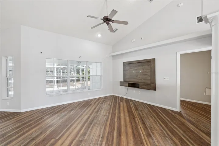 Vaulted living room with wall-mount for TV unit.