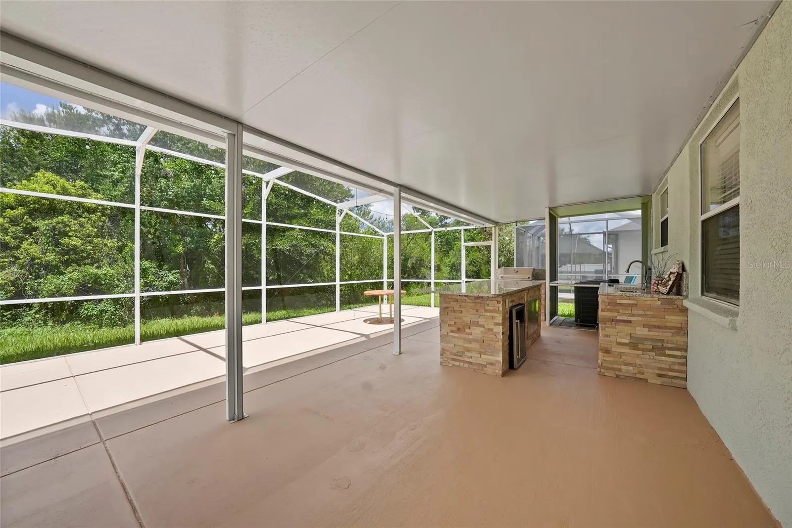 Custom screened patio with outdoor kitchen and grill