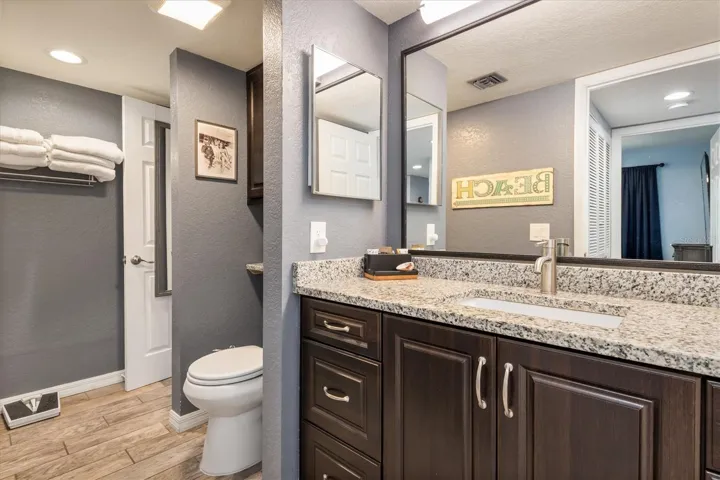 Jack and Jill Bathroom with espresso cabinets, two medicine chests and granite countertops.