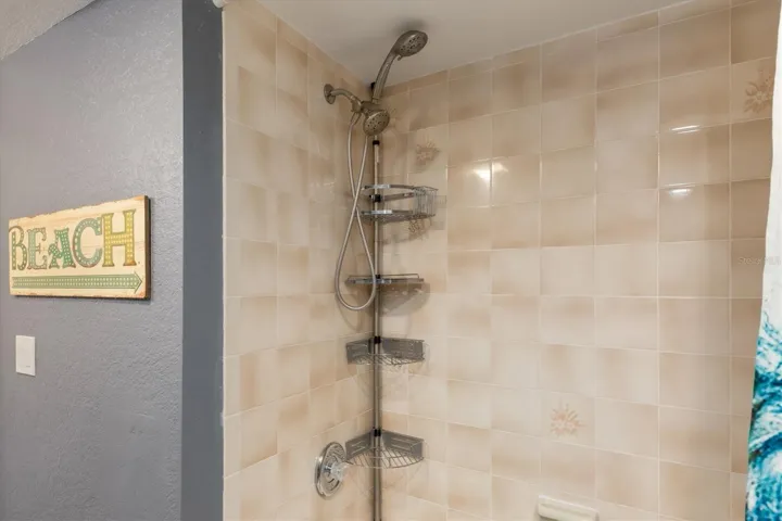 Tub shower combo with spa style fixtures.