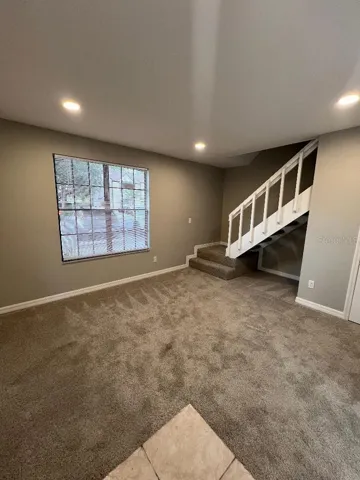 Tiled entry , guest bath and stairs.
