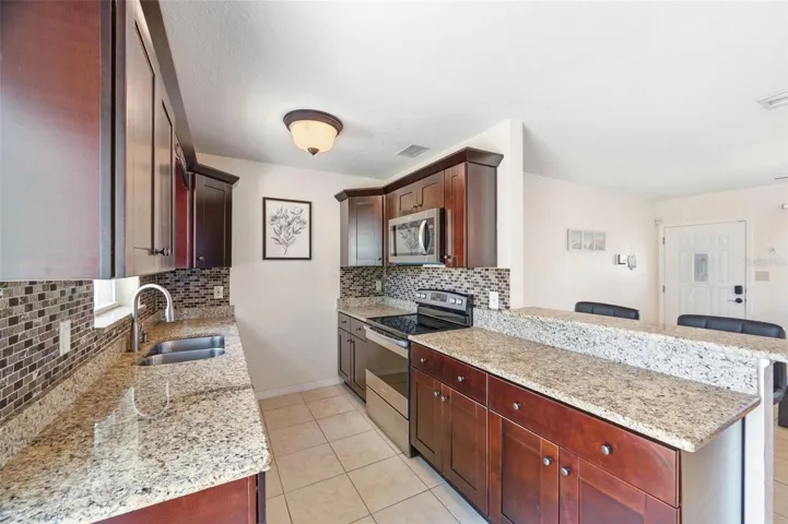 Granite countertops, stainless steel appliances and access to the Backyard through sliding doors.