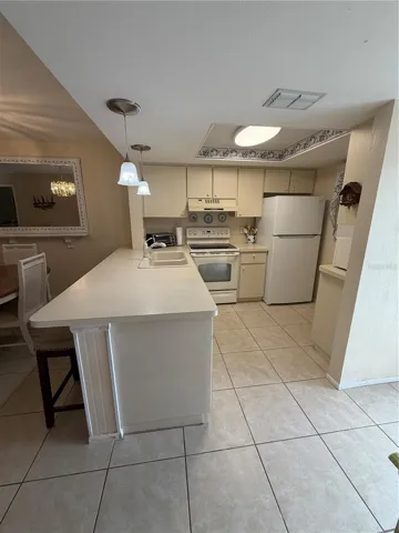 Kitchen with Breakfast Bar and Tile Flooring