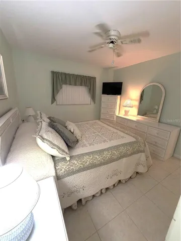 Primary Bedroom with Tile Flooring and En