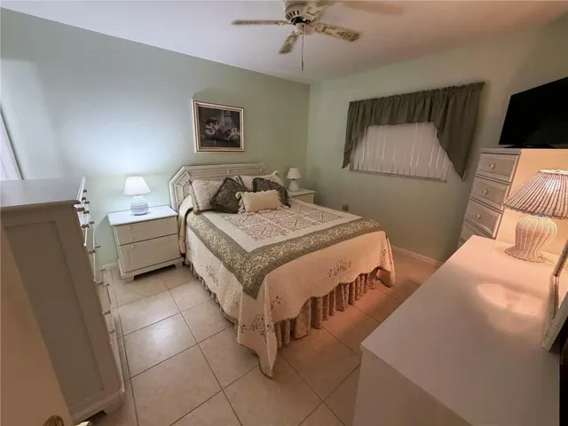 Primary Bedroom with Tile Flooring and En