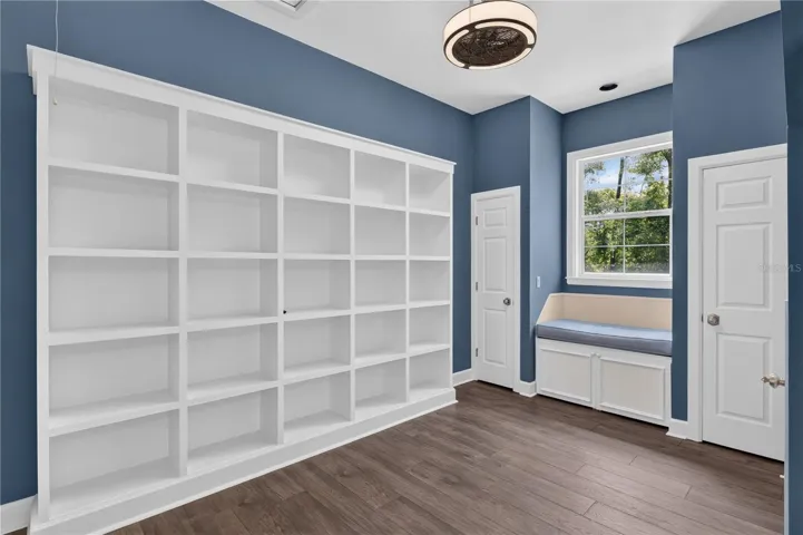 BUILT-IN SHELVING AND WINDOW SEAT AREA IN BONUS ROOM