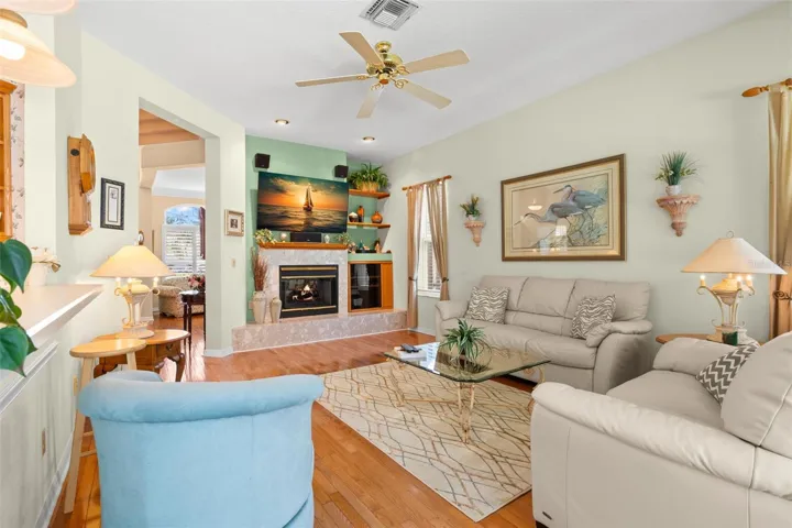 Open to the kitchen and breakfast nook, the family room is anchored by a wood-burning fireplace with built-in accents.