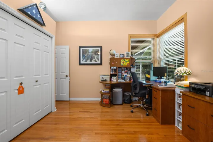 Large windows, hardwood flooring, and a built-in closet make this versatile flex space a valuable extension of the primary suite.