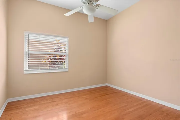 Ideal for family, guests, or a home office, this secondary bedroom features hardwood floors, a ceiling fan, and a built-in closet.