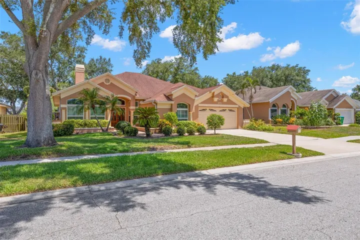 Framed by mature trees and established landscaping, this 3-bedroom, 3-bath home offers timeless curb appeal complemented by a two-car garage and spacious driveway.