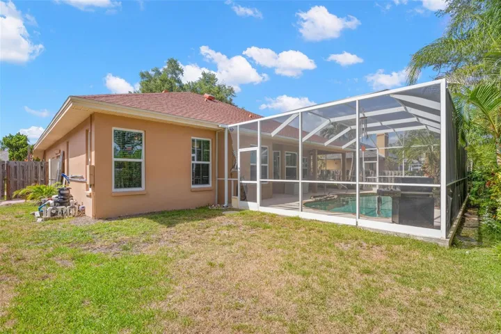 A spacious screen enclosure surrounds the pool and lanai, providing year-round enjoyment of the outdoor living areas.
