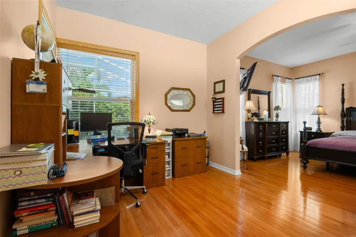 The primary suite includes a versatile flex space with a closet, ideal for a home office, nursery, fitness area, reading room, or private retreat.